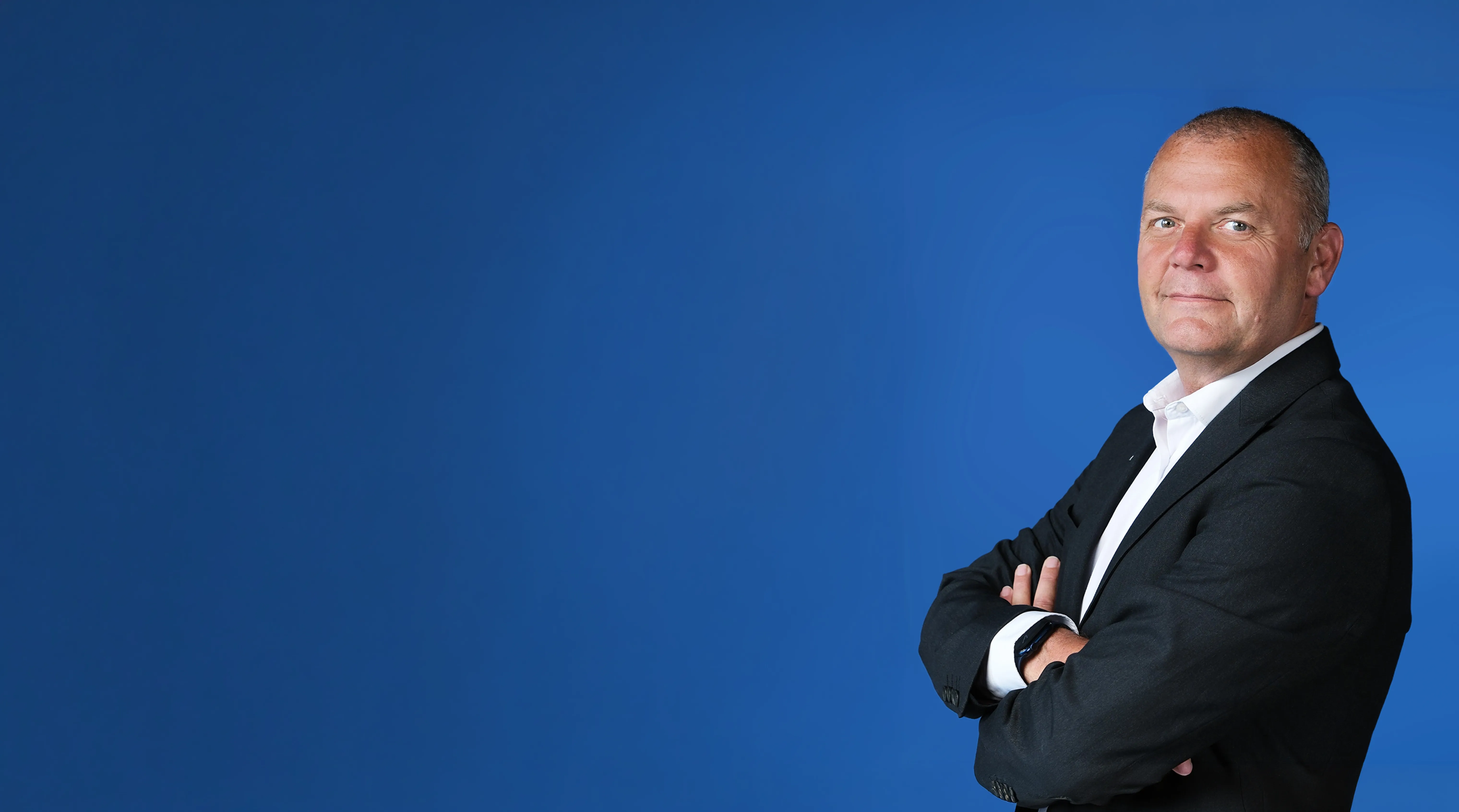 Steve Fletcher from PGI Isle of Man on a blue background