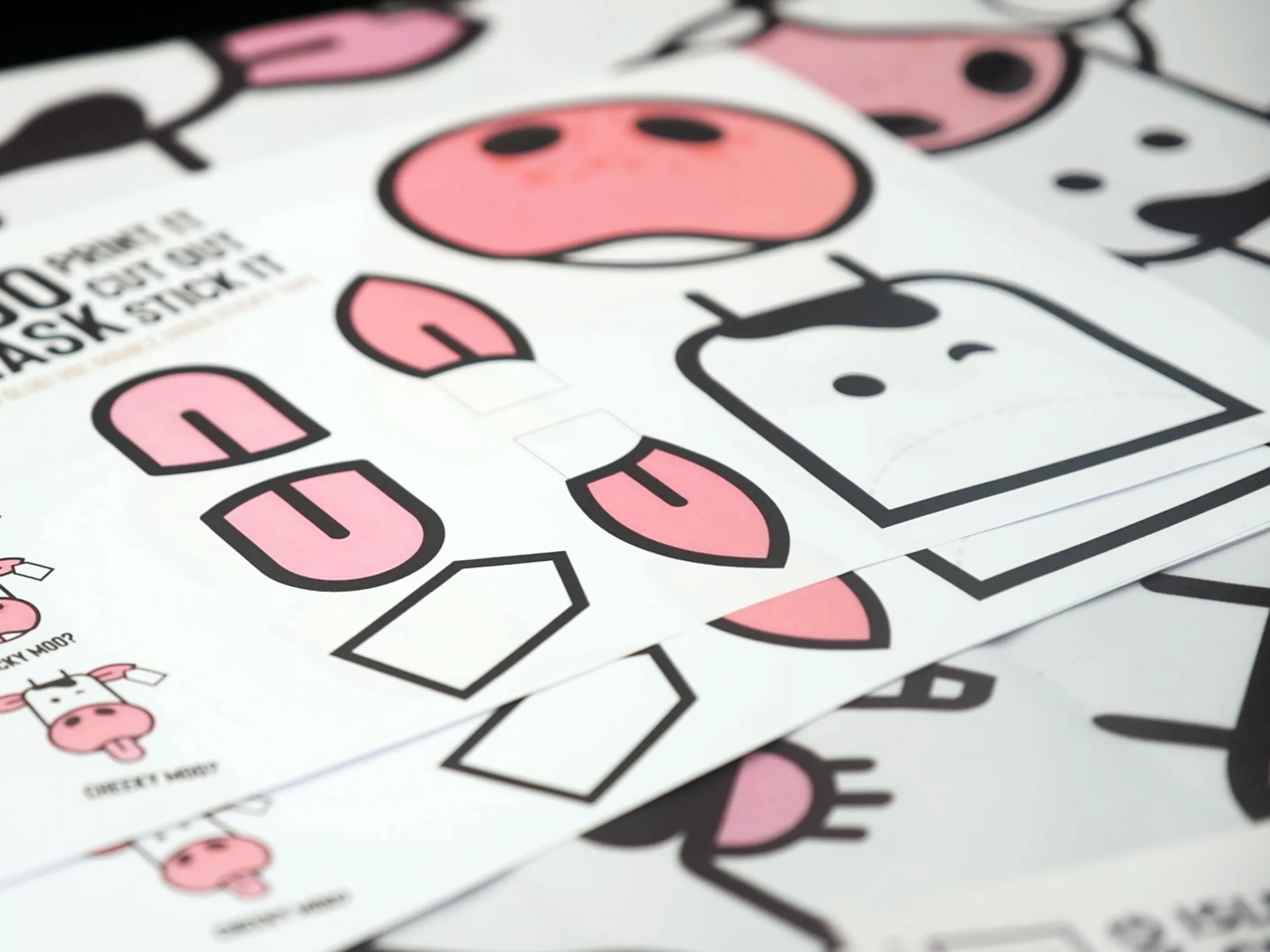 Close-up of Isle of Moo sticker sheet featuring cartoon cow faces and cut-out shapes for children’s activities.