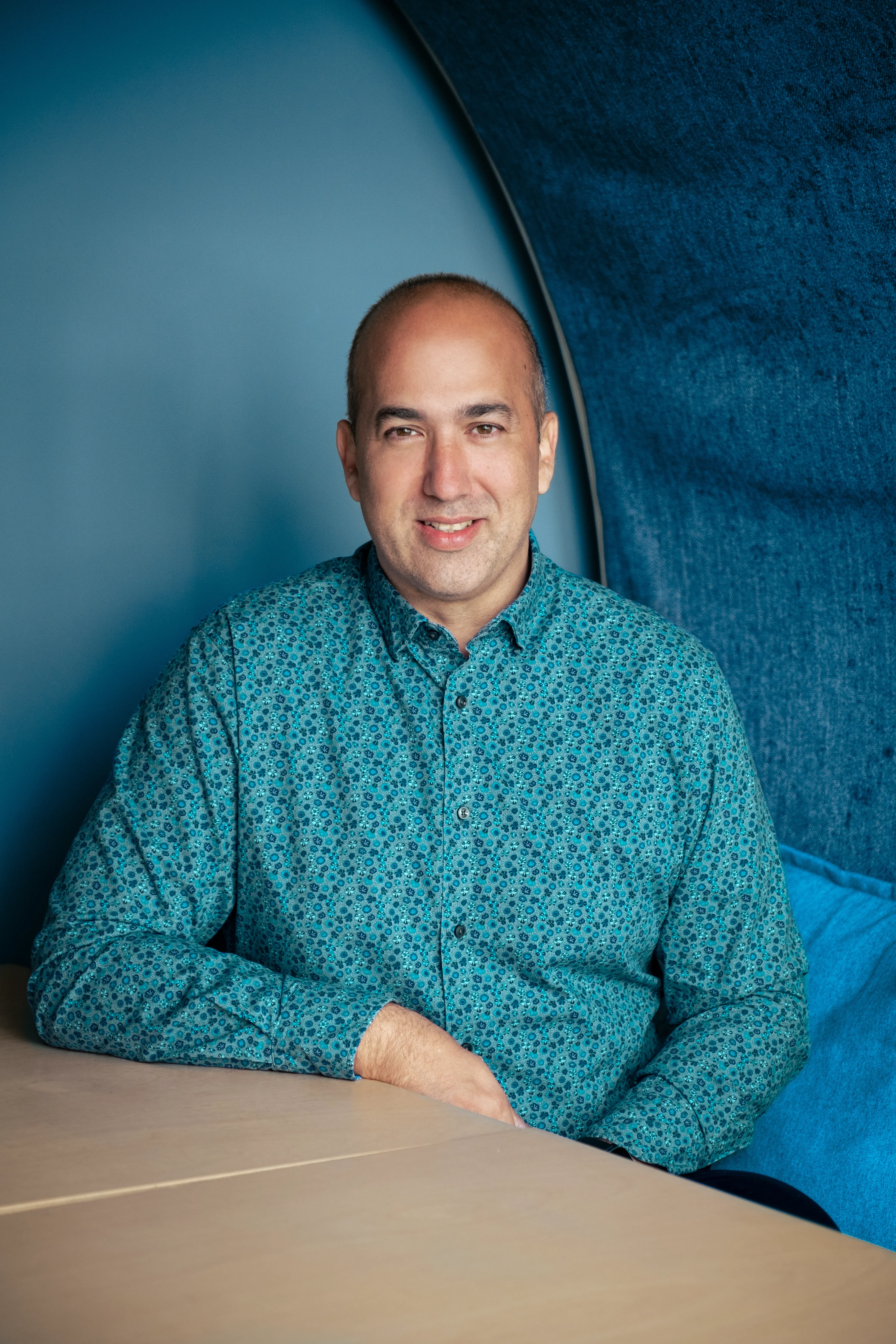 Claudiu, senior developer at Dot performance, in studio booth, smiling.