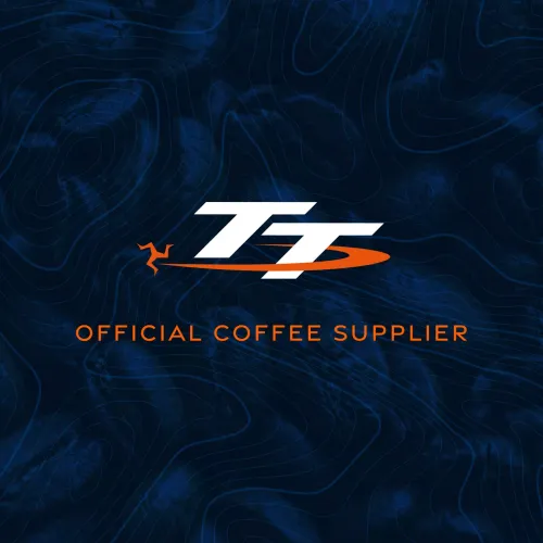 Bold white letters "TT" with an orange line beneath on a dark blue textured background. Below in orange text, it reads "Official Coffee Supplier."